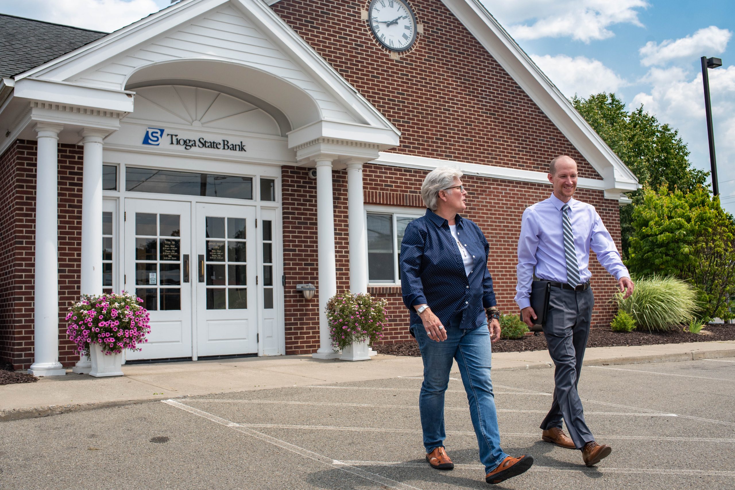 Deb Twigg and Jon Ward walking outside of Tioga State Bank