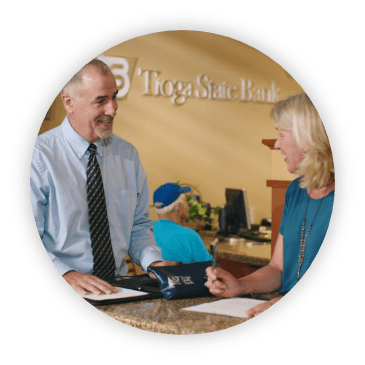 man speaking with woman at tioga bank